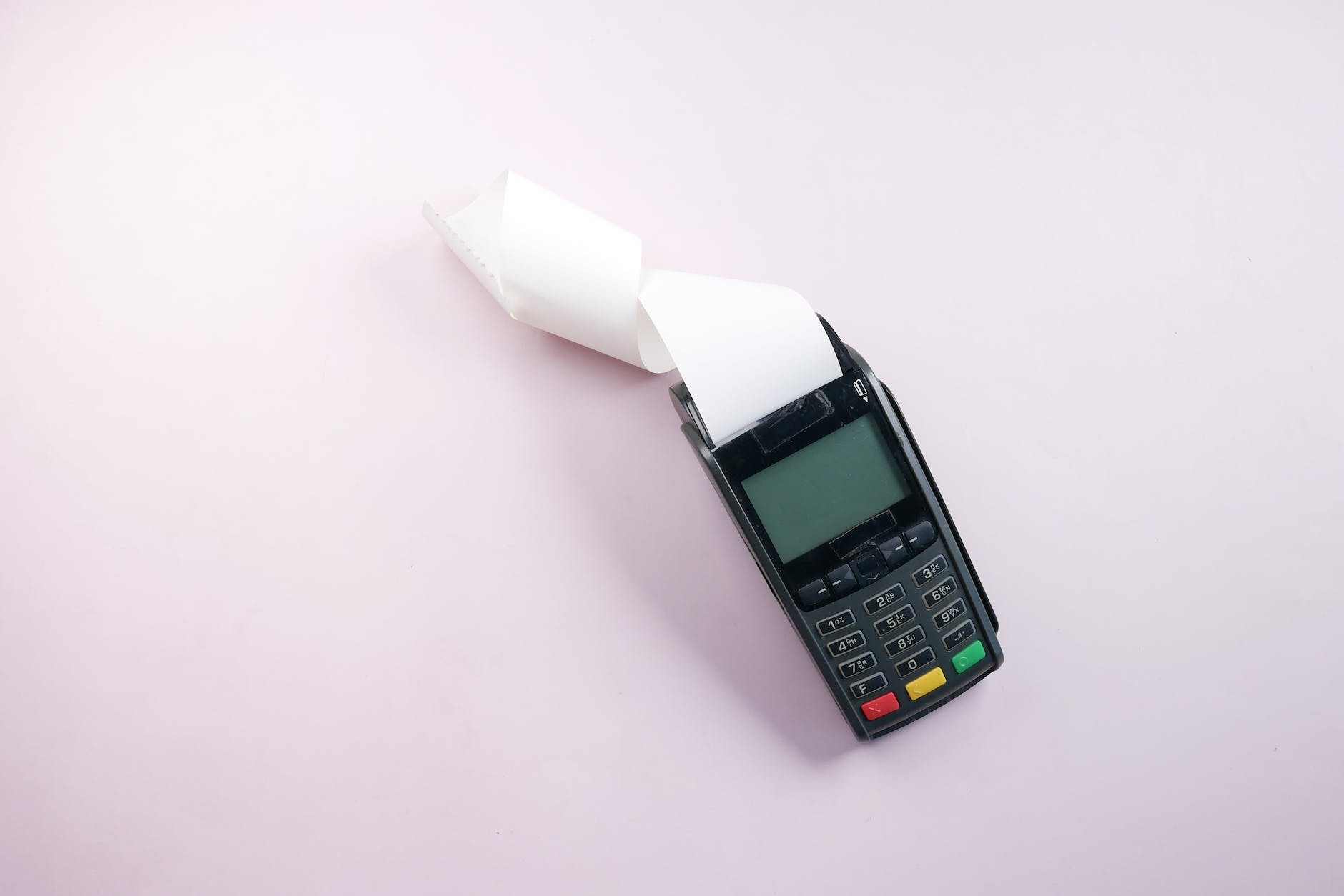payment terminal on a pink surface